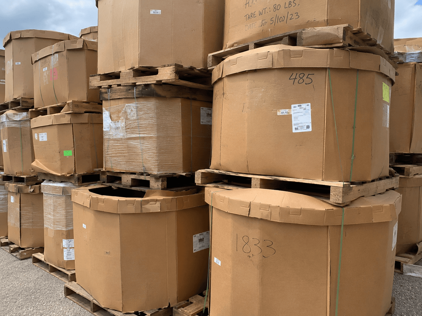 Stacked bulk bins and Gaylord lids ready to be matched and shipped