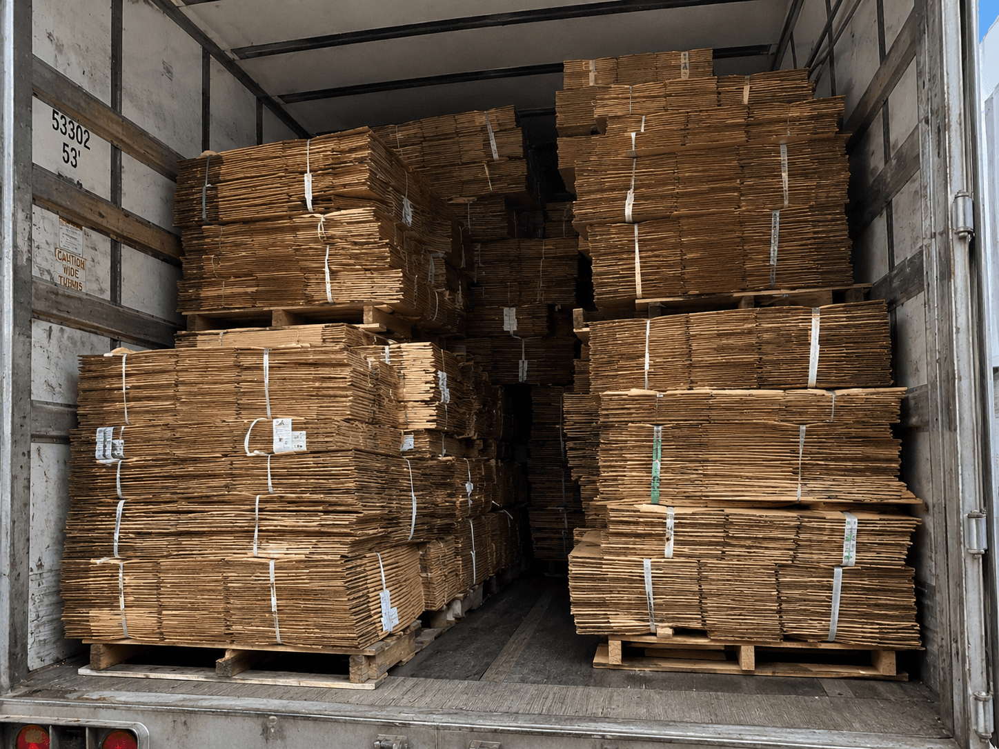 Trailer loaded with pallets of flat boxes